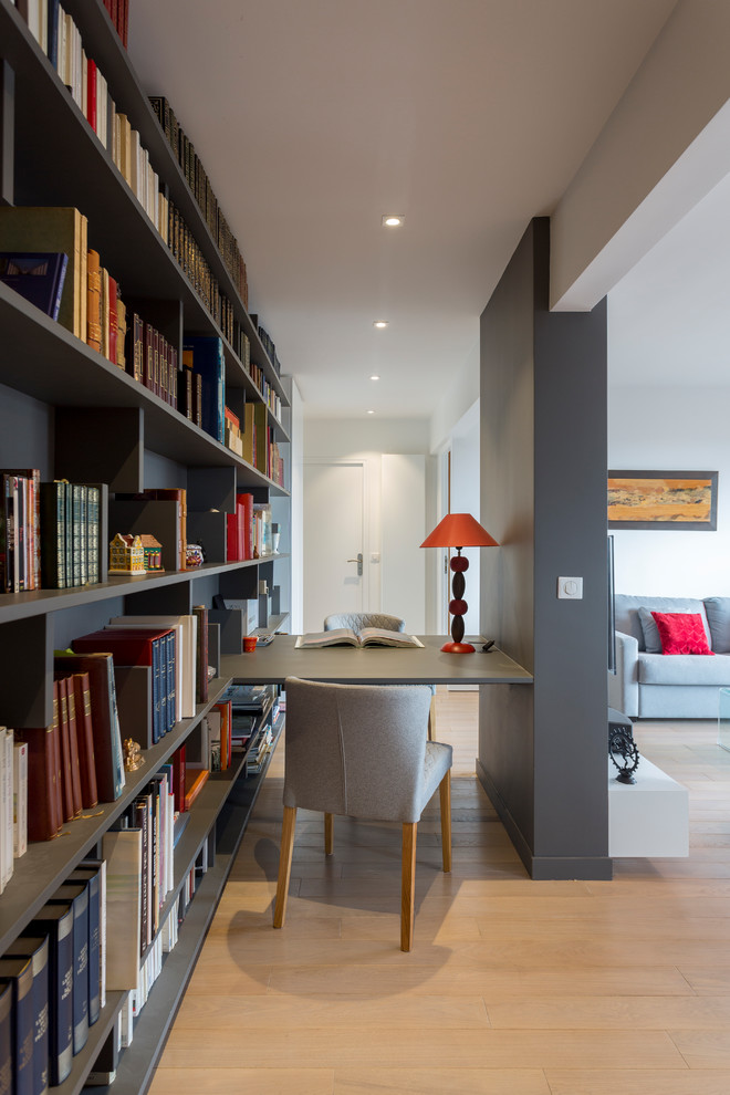 Small trendy built-in desk light wood floor and beige floor study room photo in Other with gray walls and no fireplace