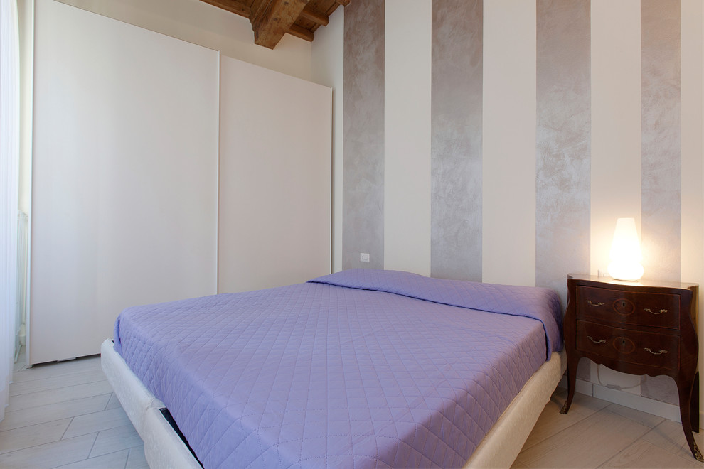 Esempio di una piccola camera matrimoniale minimal con pareti multicolore e pavimento in gres porcellanato
