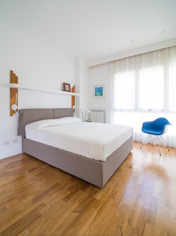 Diseño de dormitorio principal contemporáneo grande con paredes blancas y suelo de madera en tonos medios
