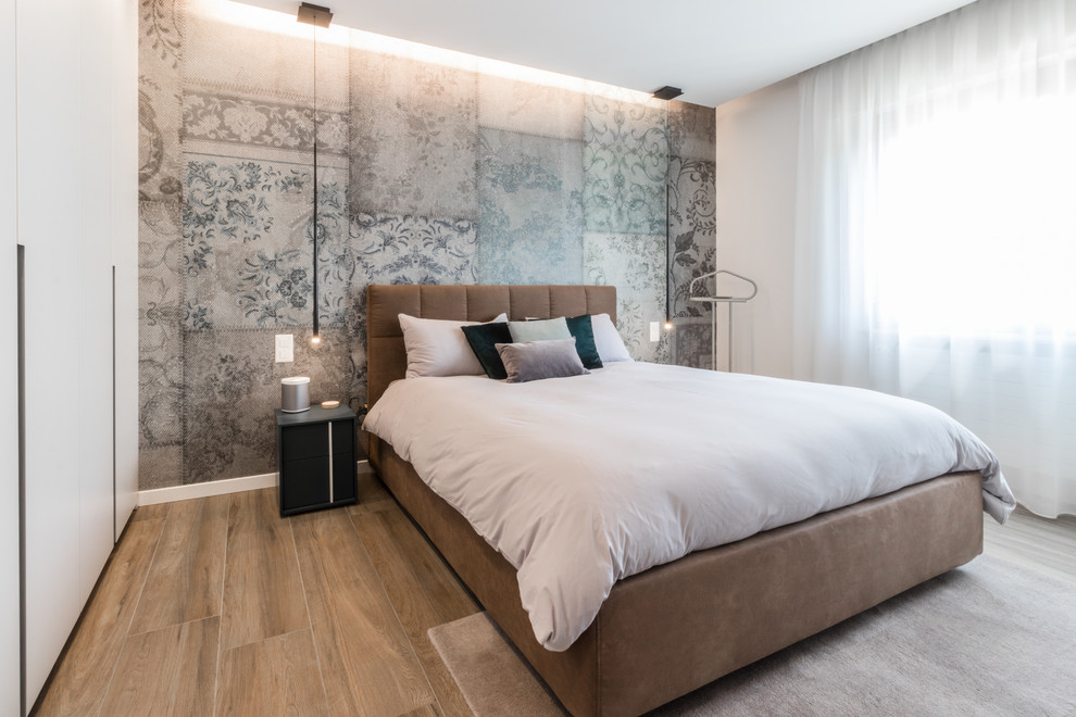 Example of a large minimalist master porcelain tile and brown floor bedroom design in Other with white walls