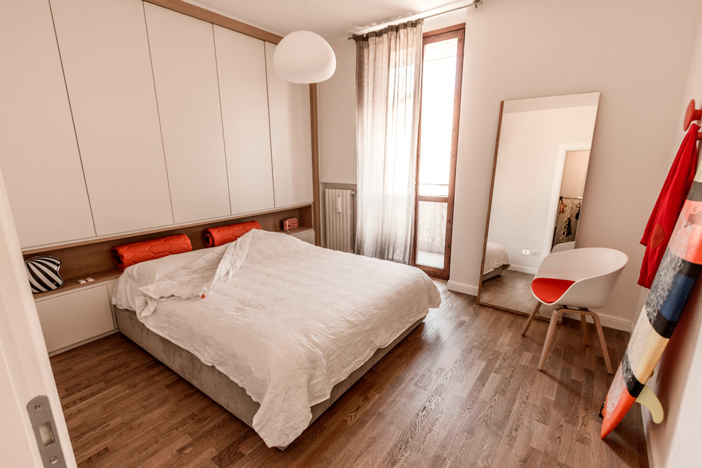 ミラノにある広いコンテンポラリースタイルのおしゃれな主寝室 (白い壁、濃色無垢フローリング)