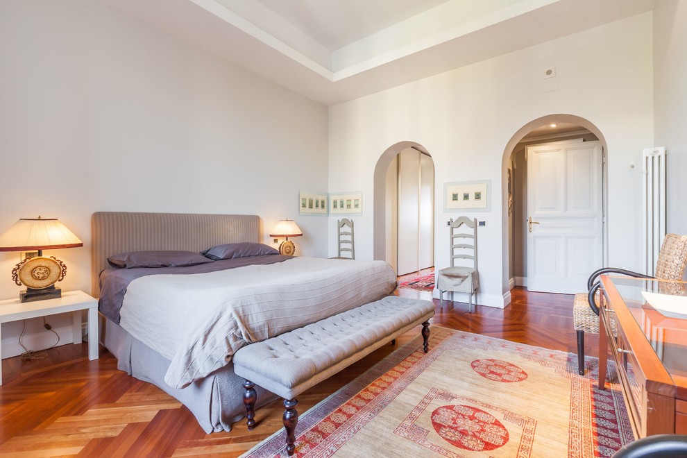 Inspiration for a large eclectic master medium tone wood floor bedroom remodel in Rome with gray walls