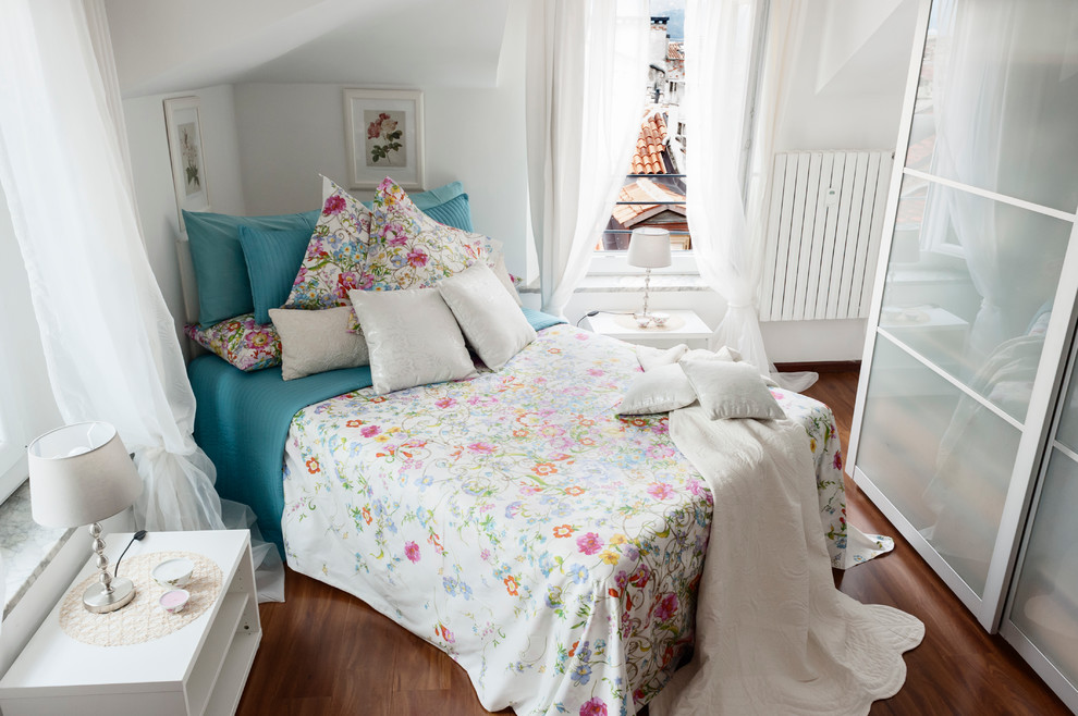 Trendy medium tone wood floor bedroom photo in Rome with white walls