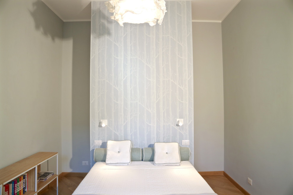 Example of a large danish light wood floor bedroom design in Rome