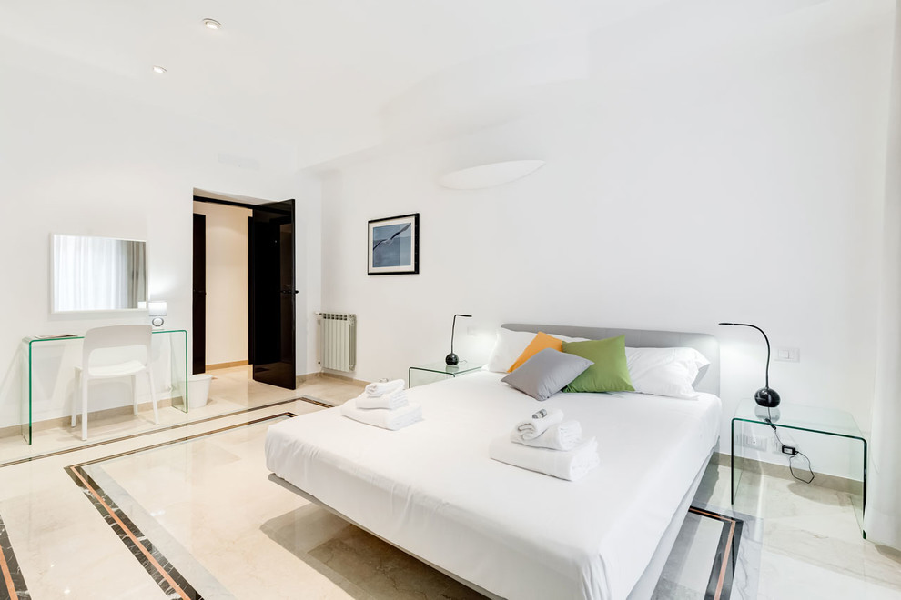 Esempio di una camera matrimoniale design di medie dimensioni con pareti bianche, pavimento in marmo e pavimento beige