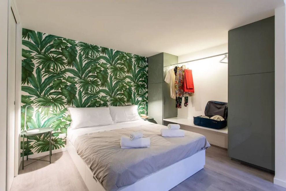 Источник вдохновения для домашнего уюта: хозяйская спальня в морском стиле с зелеными стенами, полом из ламината и обоями на стенах