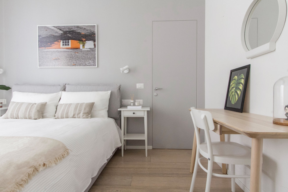 Ispirazione per una camera matrimoniale minimalista di medie dimensioni con pareti bianche e pavimento in legno massello medio