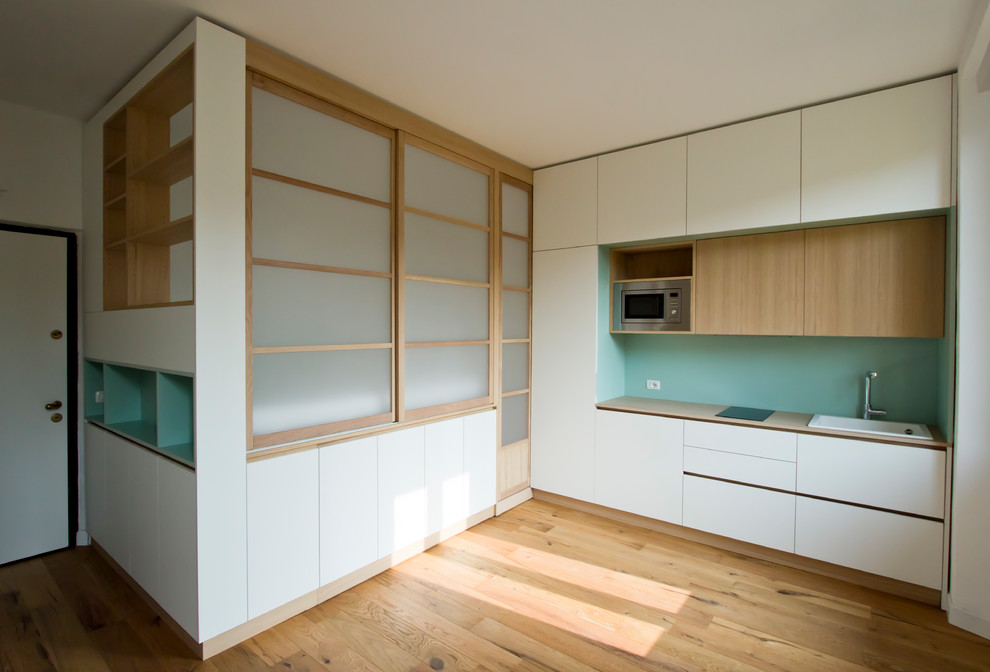 Immagine di una piccola camera da letto stile loft scandinava con parquet chiaro e pavimento marrone