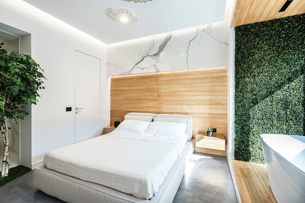 Mittelgroßes Modernes Hauptschlafzimmer ohne Kamin mit weißer Wandfarbe, Betonboden und grauem Boden in Rom