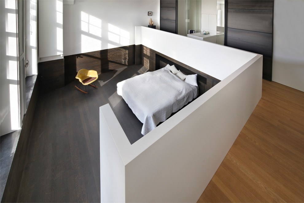 Foto de dormitorio minimalista sin chimenea con paredes blancas y suelo de madera oscura