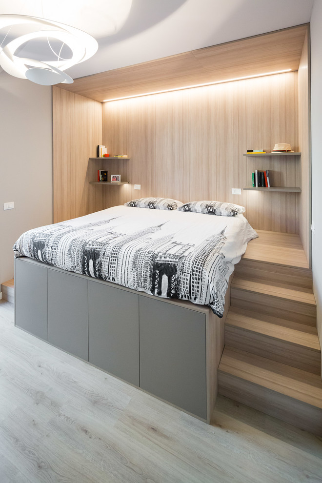 Diseño de dormitorio principal contemporáneo pequeño con paredes beige, suelo de madera clara y suelo beige