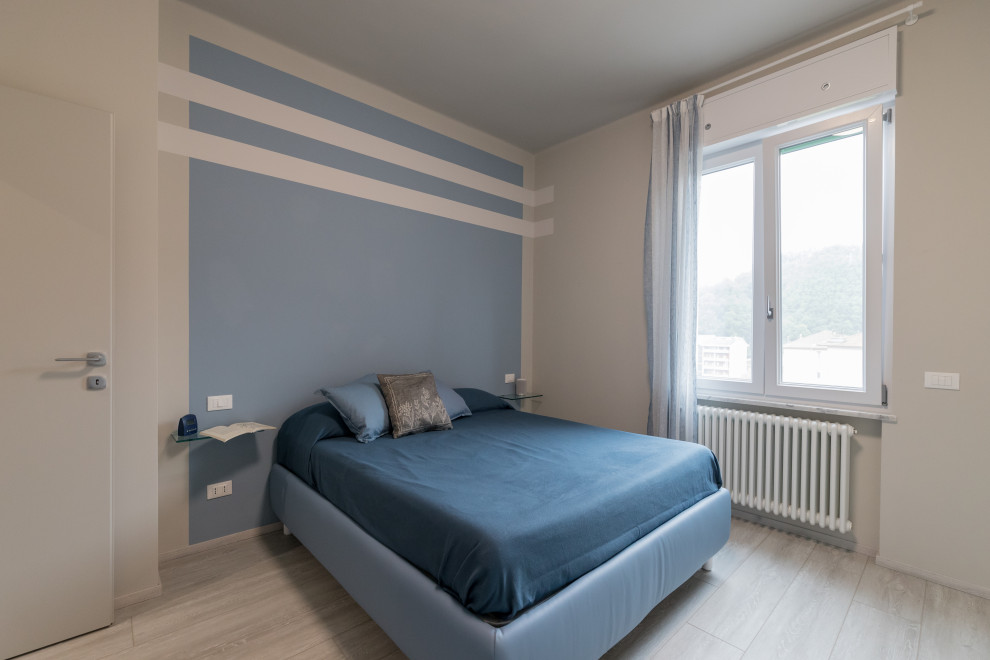 This is an example of a large contemporary master bedroom in Other with blue walls, porcelain flooring and beige floors.