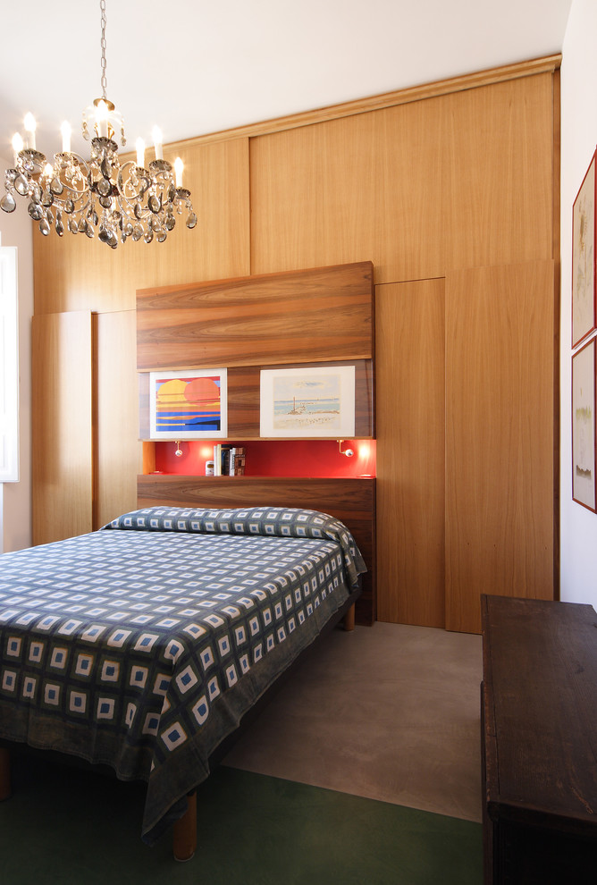 Imagen de dormitorio principal moderno de tamaño medio con paredes blancas y suelo de cemento