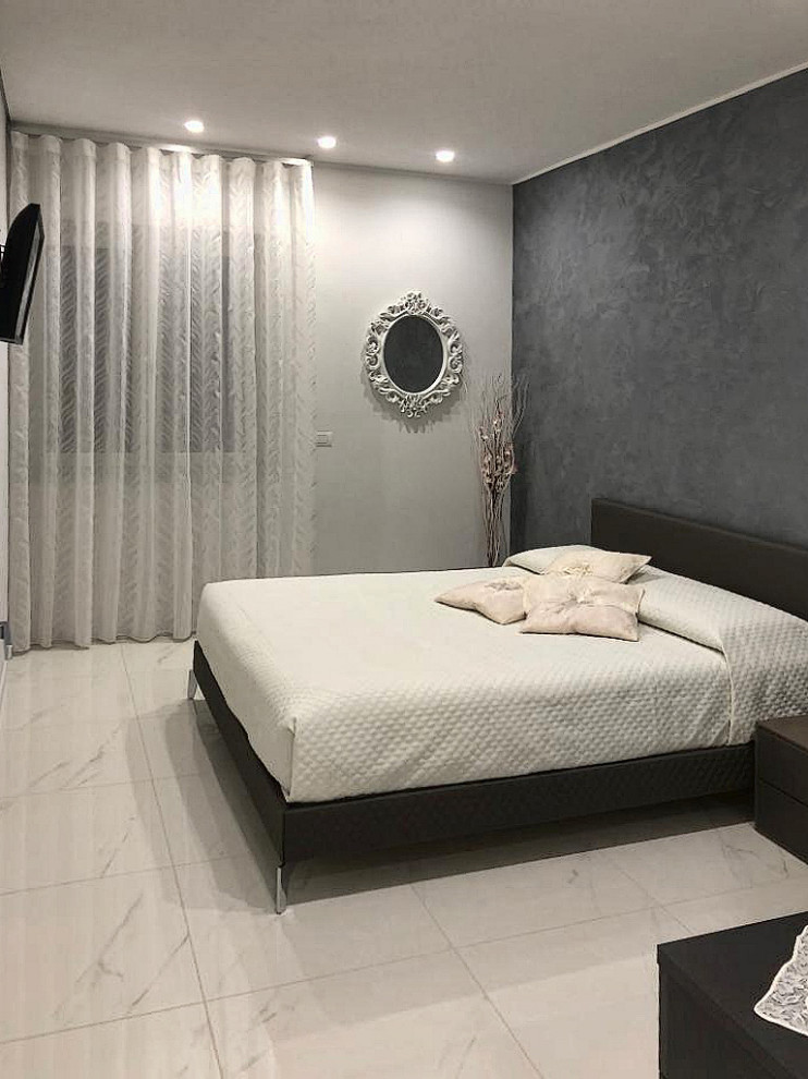 Mittelgroßes Modernes Hauptschlafzimmer ohne Kamin mit grauer Wandfarbe, Porzellan-Bodenfliesen und weißem Boden in Sonstige