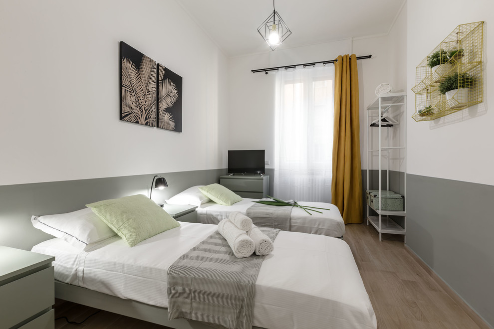 Example of a mid-sized trendy guest porcelain tile and brown floor bedroom design in Milan with green walls and no fireplace