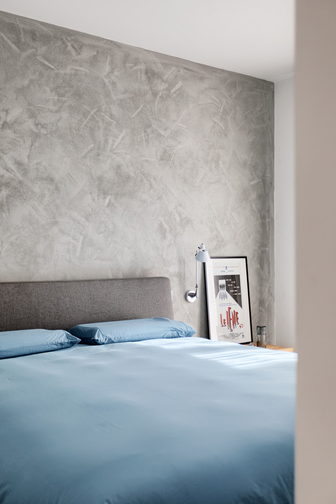 Inspiration for a medium sized contemporary master bedroom in Bologna with grey walls and grey floors.