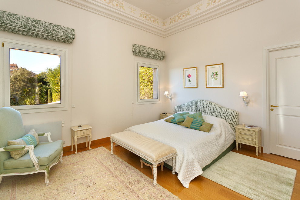 Idee per una camera matrimoniale tradizionale con pareti bianche, pavimento in legno massello medio e pavimento marrone