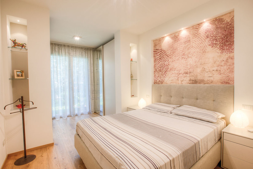 Example of a trendy master medium tone wood floor bedroom design in Bologna