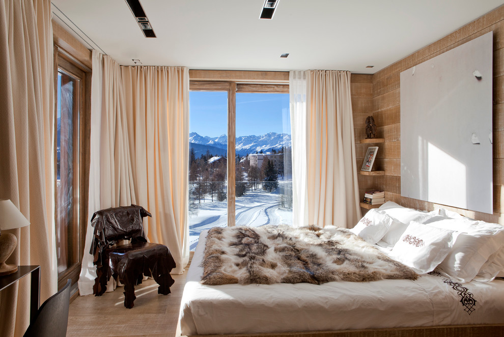 This is an example of a rustic master bedroom in Other with light hardwood flooring.