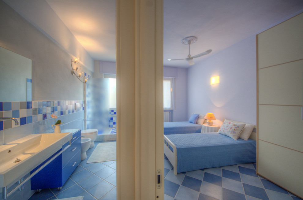 Photo of a beach style bedroom in Other with blue walls and blue floors.
