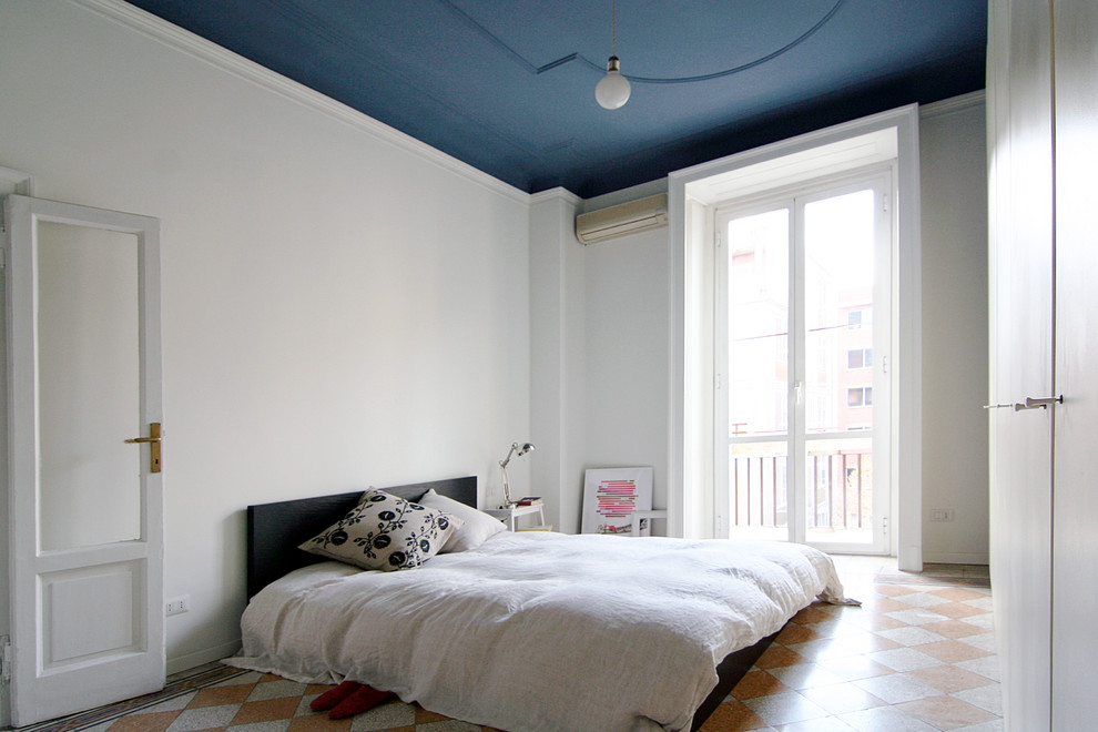 Photo of a midcentury bedroom in Milan with white walls.