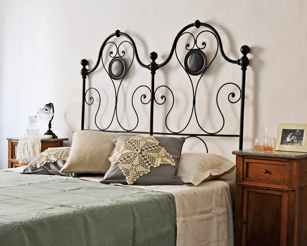 Inspiration for a medium sized mediterranean guest bedroom in Rome with white walls.