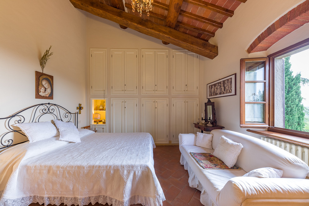 Idéer för medelhavsstil sovrum, med beige väggar, klinkergolv i terrakotta och rött golv