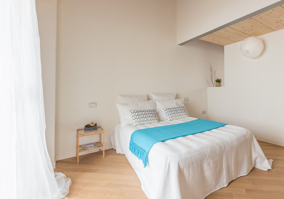 Ejemplo de dormitorio escandinavo con paredes blancas y suelo de madera clara