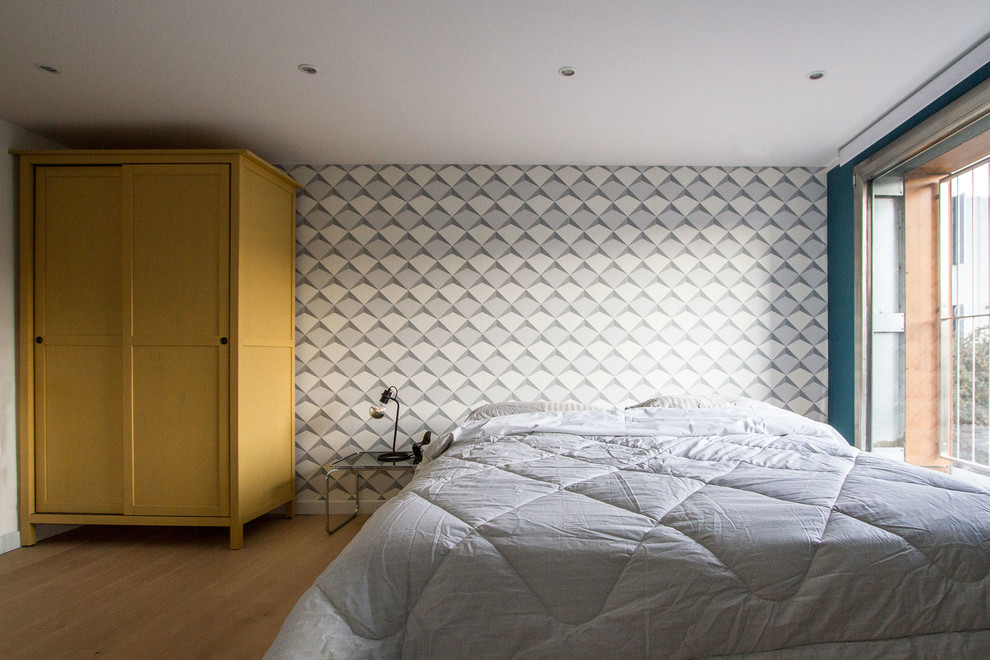 Esempio di una piccola camera da letto stile loft design con pareti multicolore e pavimento in legno massello medio