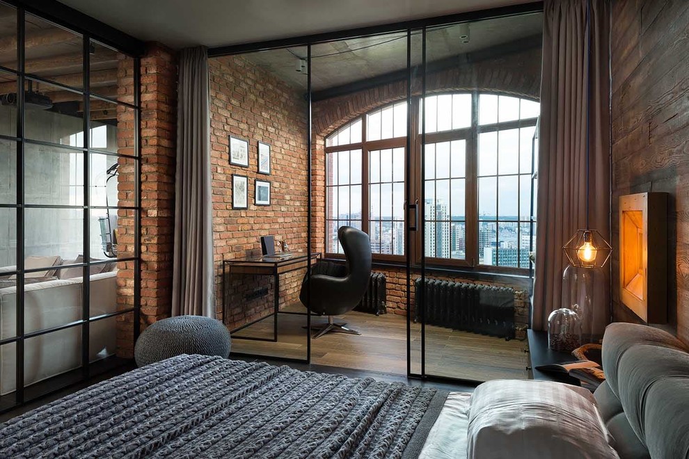 Photo of an industrial mezzanine bedroom in Bologna with ceramic flooring and brown floors.
