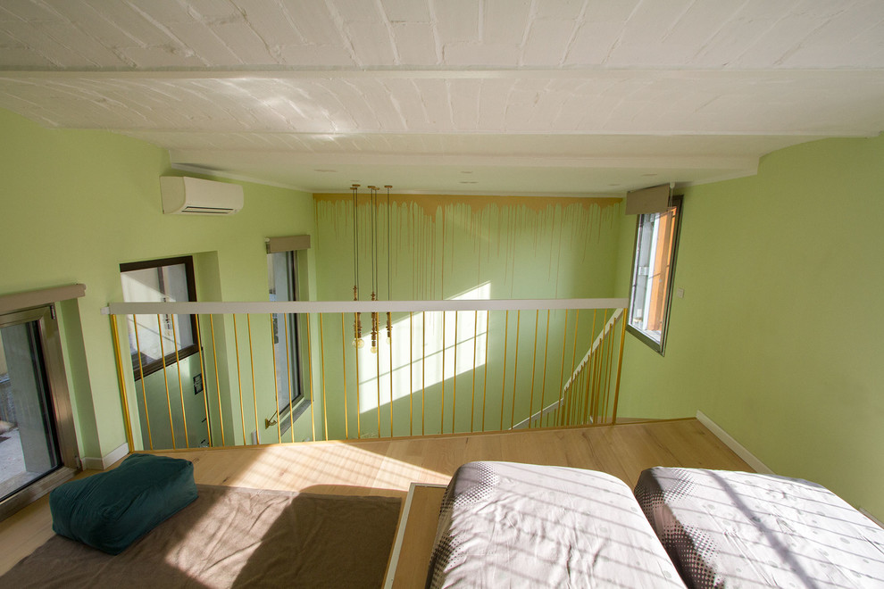 На фото: спальня среднего размера в стиле модернизм с зелеными стенами и паркетным полом среднего тона
