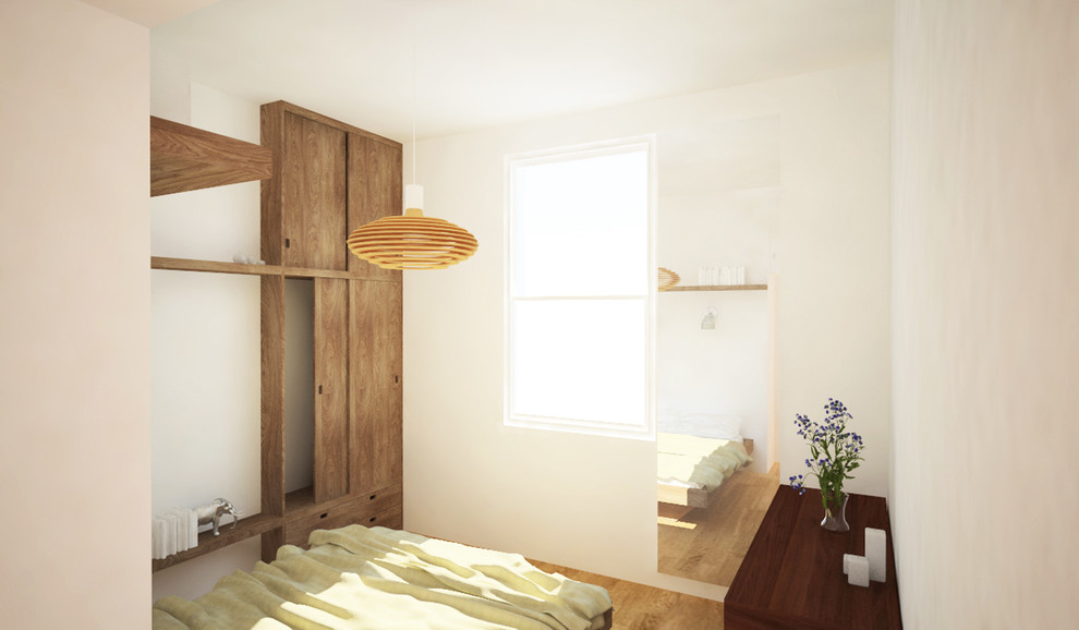 Photo of a medium sized scandinavian master bedroom in London with medium hardwood flooring.