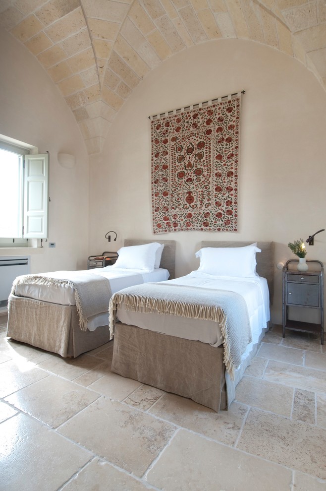 На фото: спальня в средиземноморском стиле с бежевыми стенами и бежевым полом с