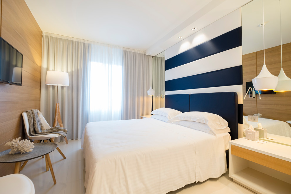 Photo of a medium sized contemporary master bedroom in Bologna with porcelain flooring, beige walls and beige floors.