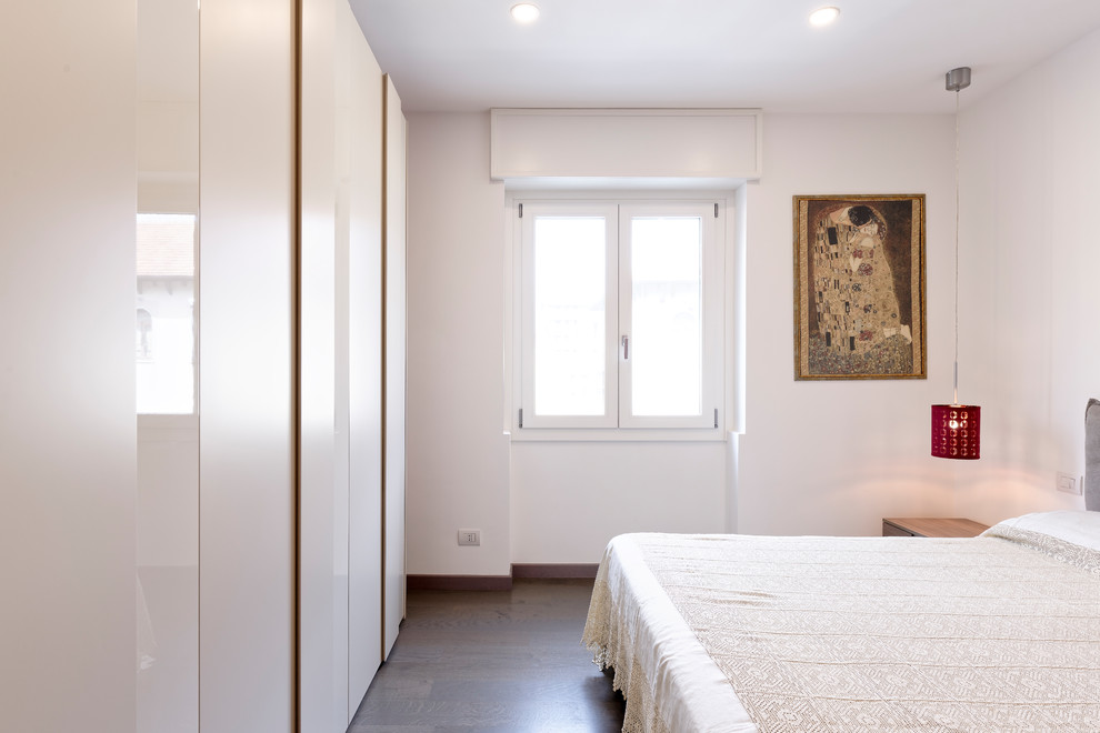 Inspiration for a mid-sized master dark wood floor and brown floor bedroom remodel in Milan with white walls