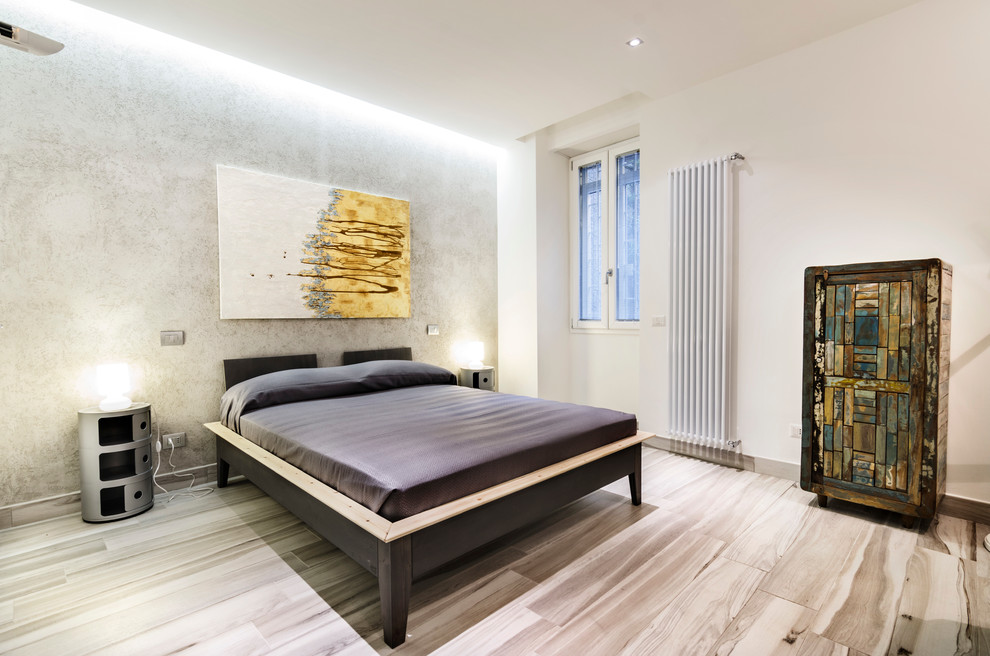Photo of a contemporary guest and grey and silver bedroom in Rome with light hardwood flooring, no fireplace and white walls.