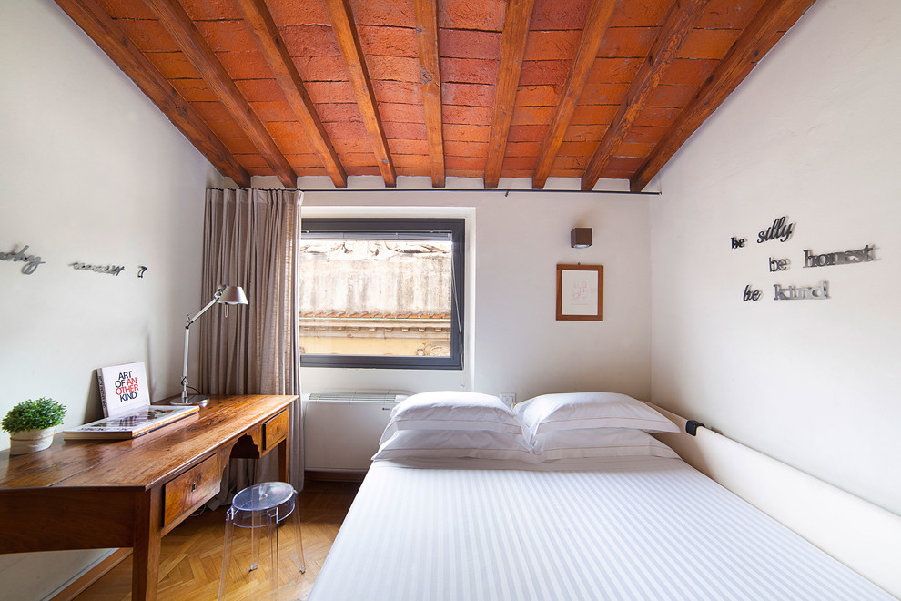 На фото: спальня в средиземноморском стиле с белыми стенами, паркетным полом среднего тона и коричневым полом с