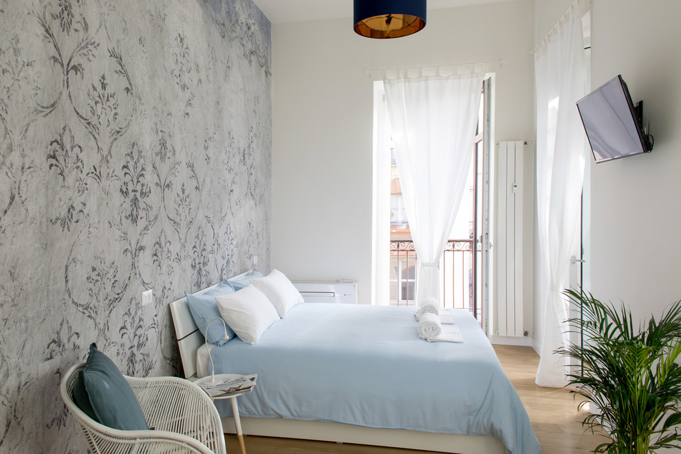 Maritimes Gästezimmer mit beiger Wandfarbe, hellem Holzboden und beigem Boden in Turin