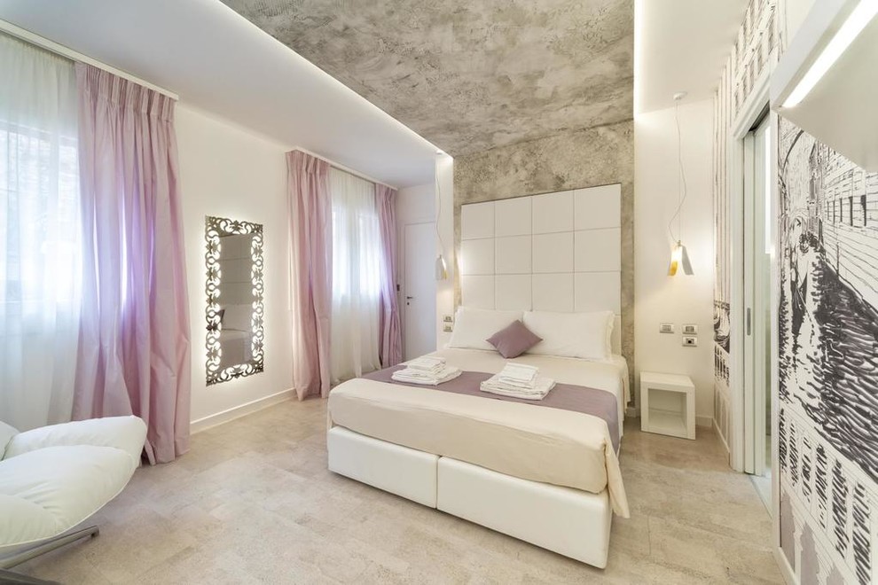 This is an example of a small contemporary master bedroom in Venice with white walls, cork flooring and white floors.