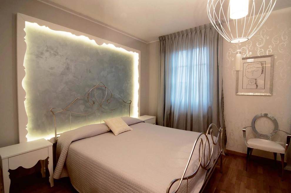 Example of a mid-sized trendy master light wood floor bedroom design in Florence with white walls