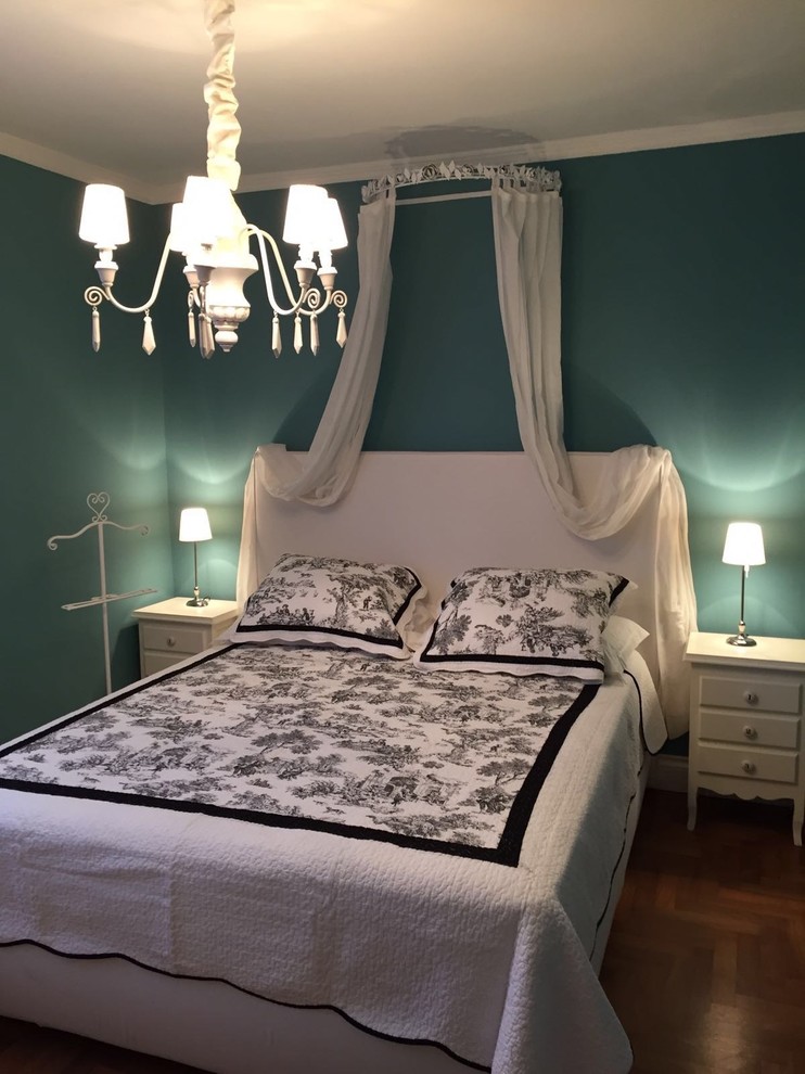 Immagine di una camera degli ospiti chic di medie dimensioni con pareti blu e pavimento in legno massello medio