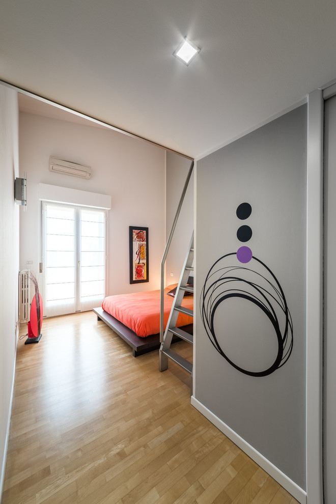 Ejemplo de dormitorio principal urbano grande con paredes multicolor, suelo de madera clara y suelo beige