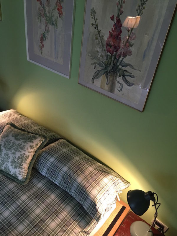 Immagine di una camera da letto bohémian di medie dimensioni con pareti verdi e pavimento in gres porcellanato