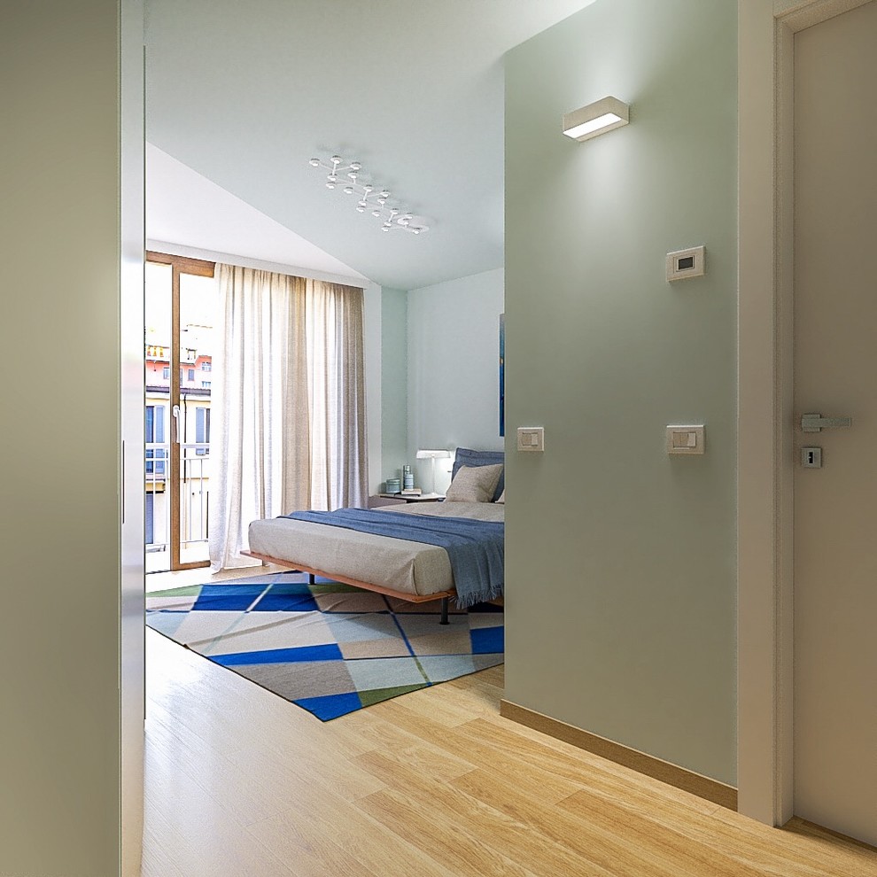ミラノにある中くらいなコンテンポラリースタイルのおしゃれな主寝室 (緑の壁、淡色無垢フローリング、茶色い床) のインテリア