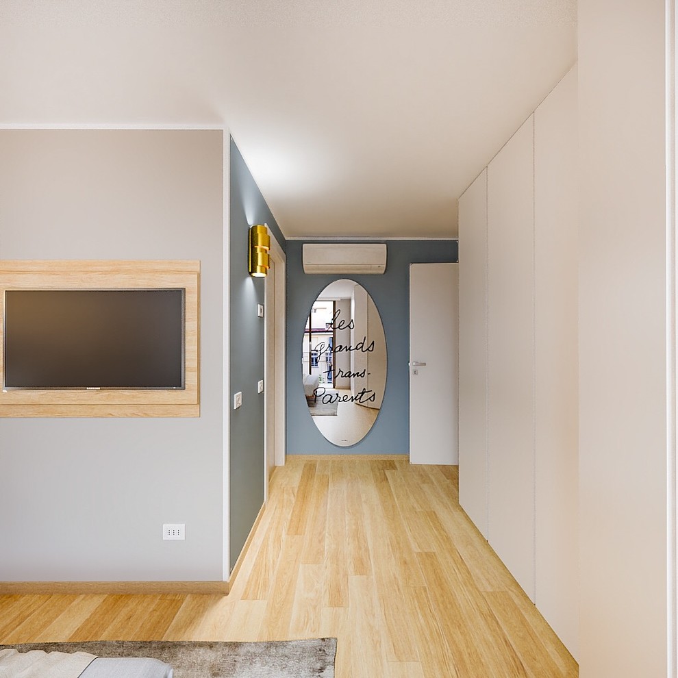 Inspiration for a mid-sized contemporary master light wood floor bedroom remodel in Milan with blue walls