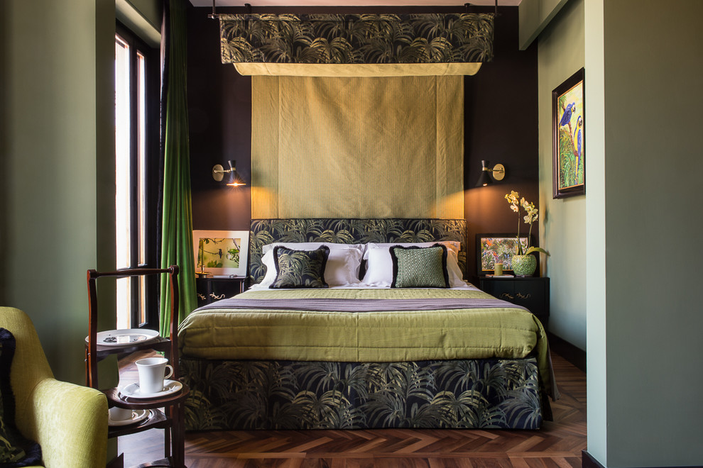 Photo of an eclectic bedroom in Florence with green walls and dark hardwood flooring.