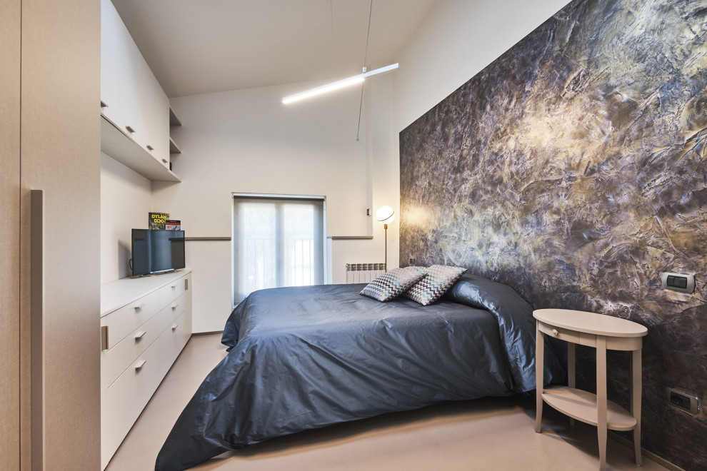 Photo of a small contemporary guest bedroom in Florence with white walls, concrete flooring and beige floors.