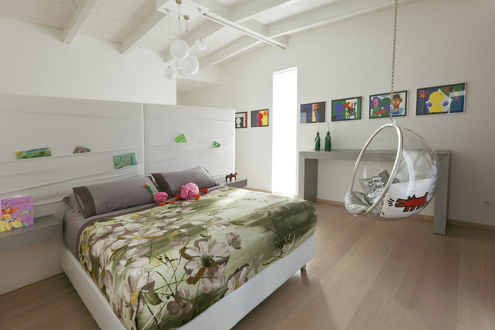 Example of a mid-sized trendy master light wood floor and beige floor bedroom design in Other with white walls