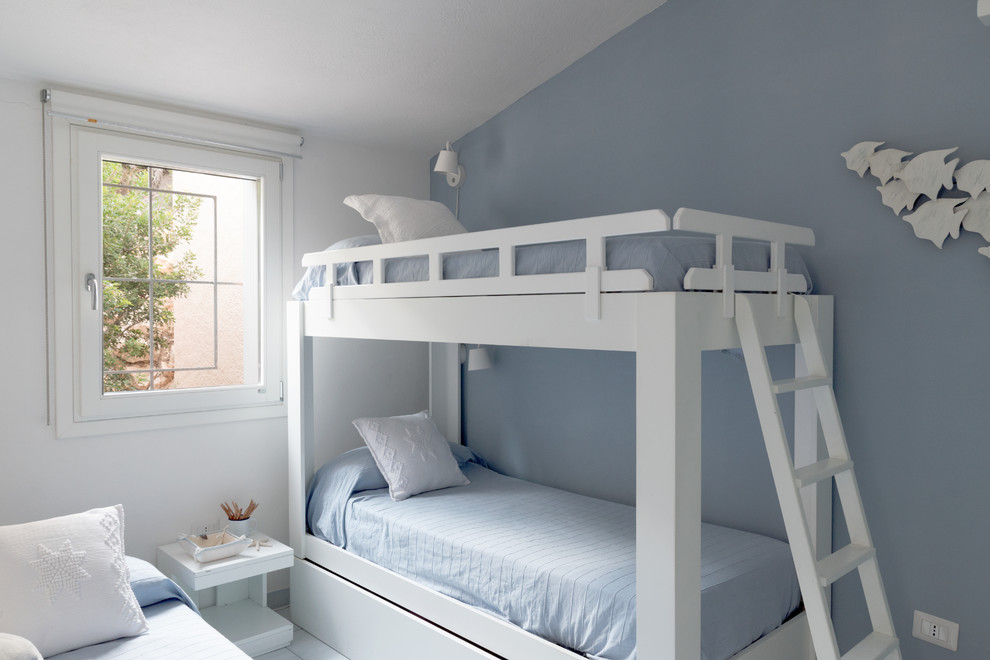 This is an example of a medium sized beach style gender neutral children’s room in Other with blue walls.