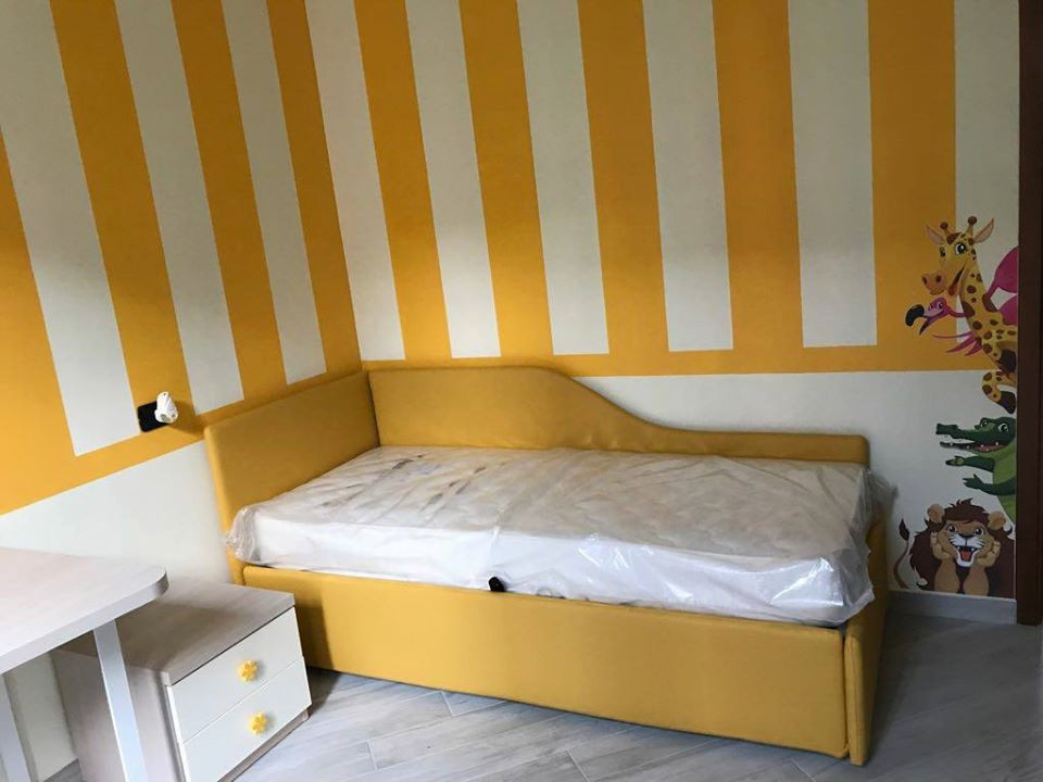 Inspiration for a small modern gender neutral teen’s room in Milan with yellow walls.